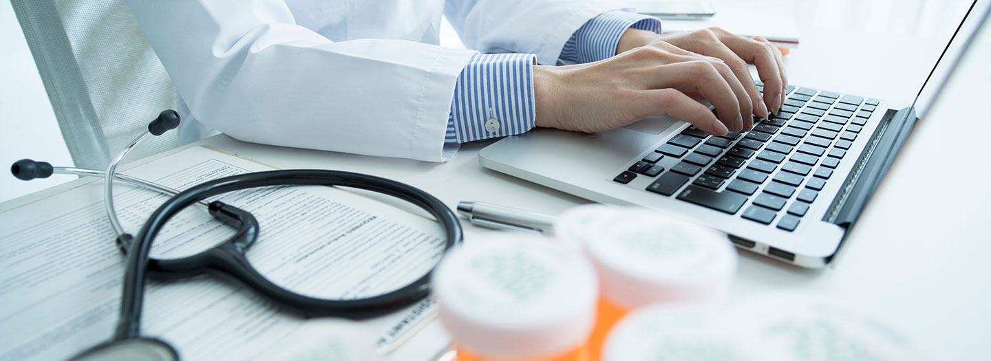 Female doctor is using a calculator.