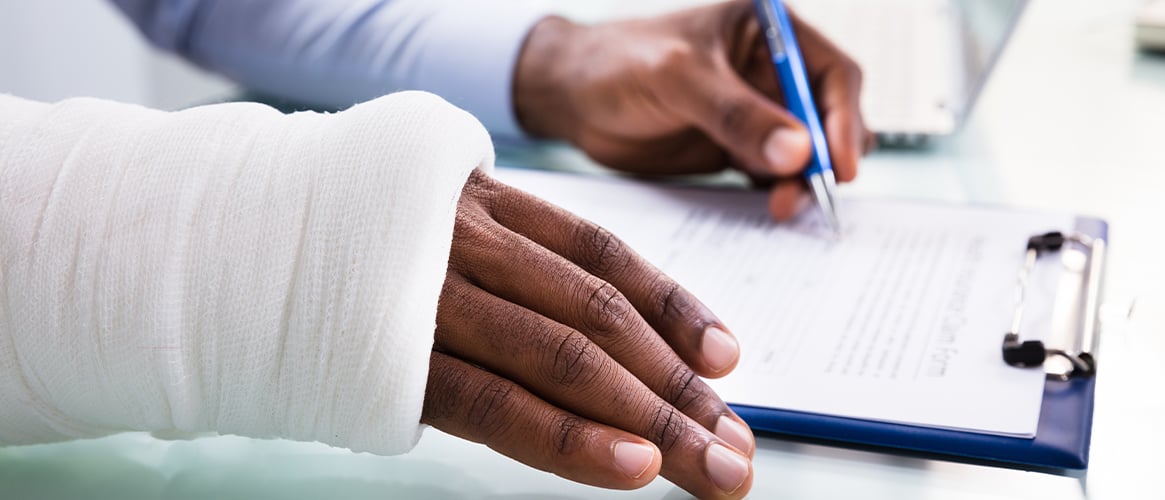 Injured worker filling out paperwork.