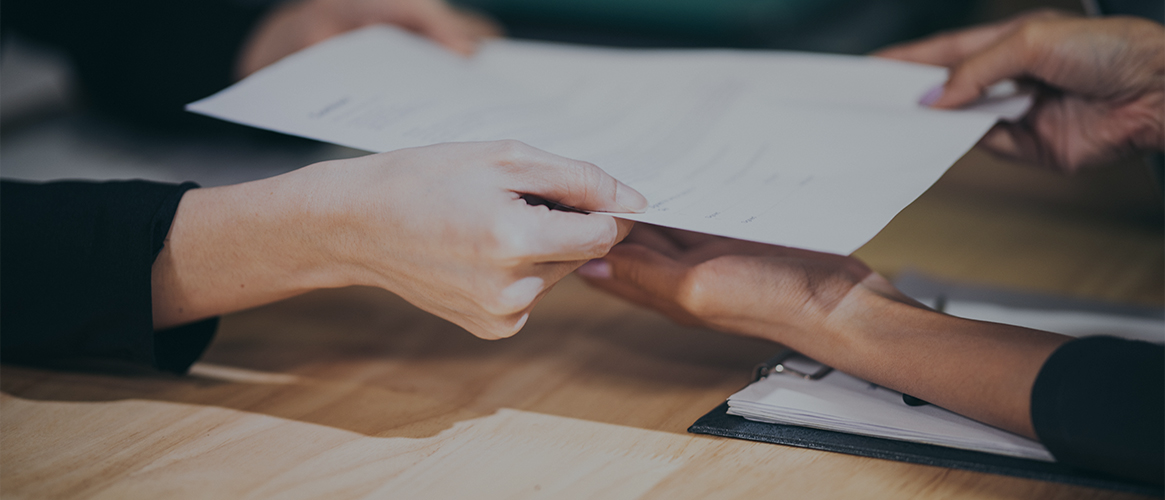 Insurance agent hands client waiver of subrogation form.