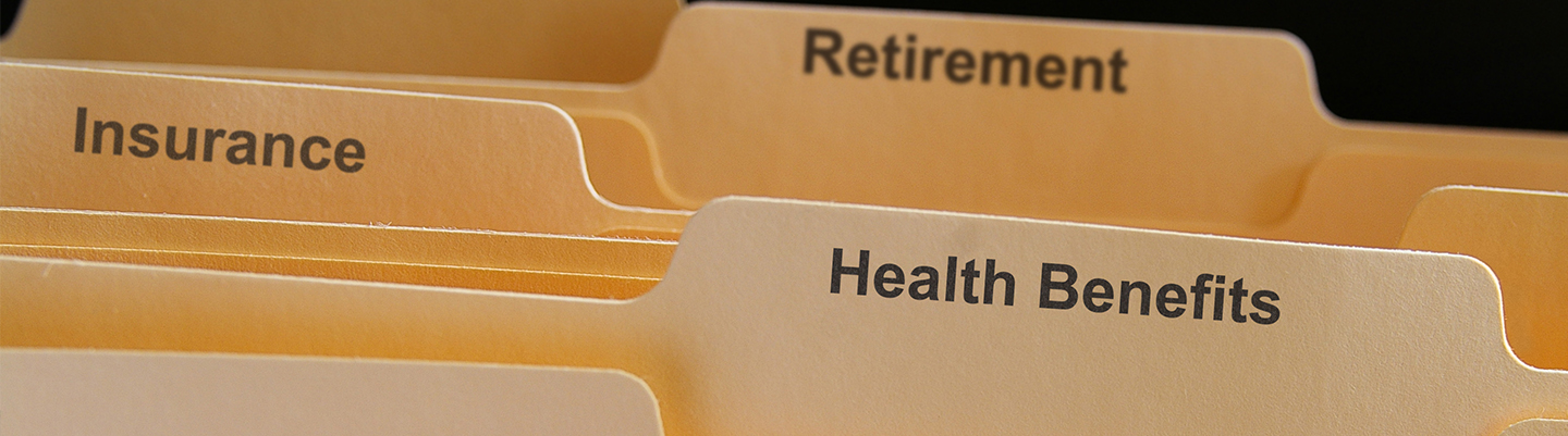 File folders with employee befits, health, retirement, insurance.